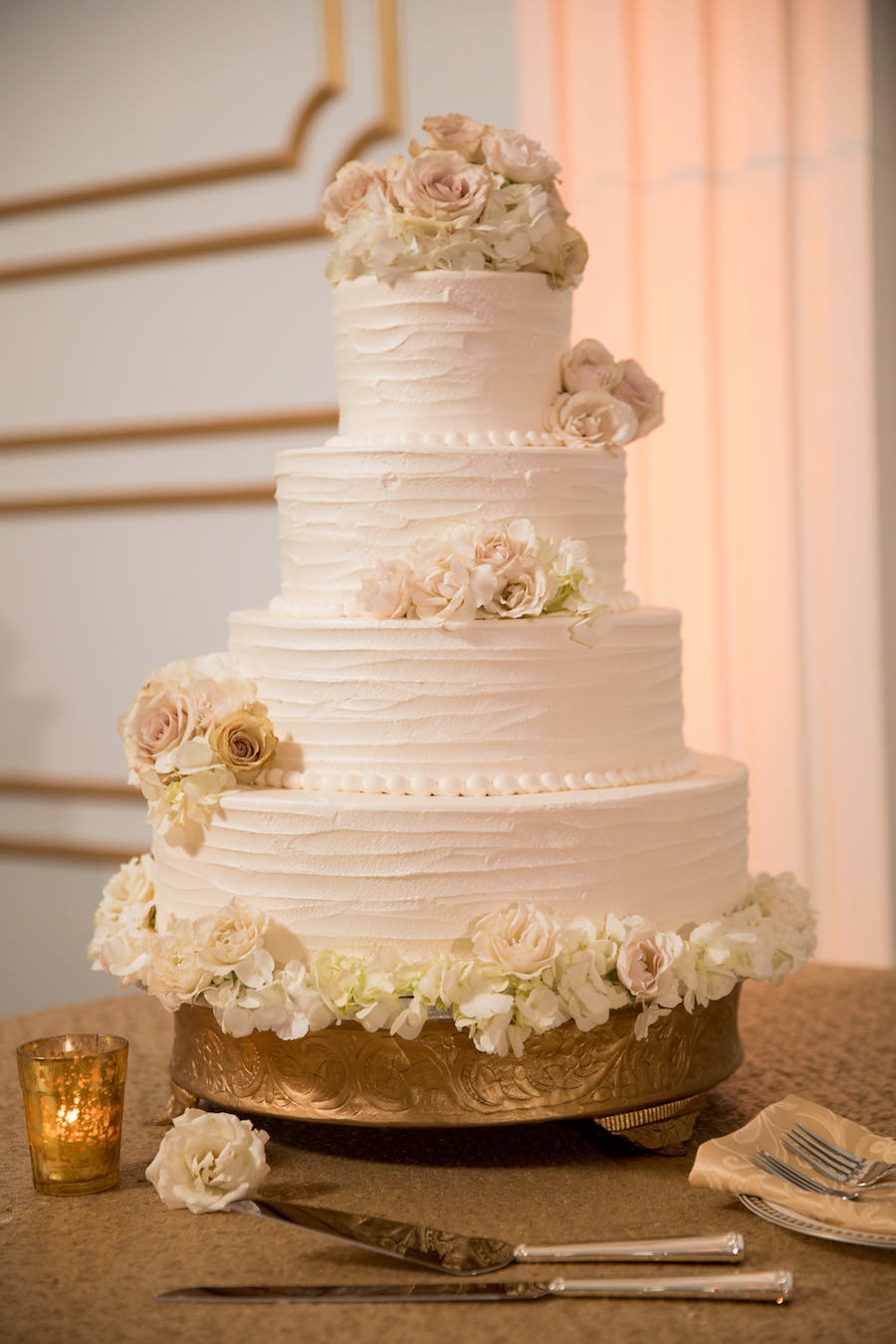 Four Tier Round White Wedding Cake with Blush and Ivory Roses on Gold Cake Stand