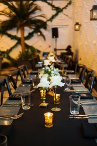 Vintage Inspired Wedding Reception with Black, Gold and Ivory Centerpieces on Long Feasting Tables