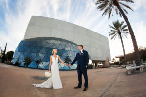 St. Pete Bride and Groom Wedding Portrait in Navy Blue Suit and Ivory Mikaella Wedding Dress | Downtown St. Pete Wedding Venue Dali Musuem | Photographer Limelight Photography | Wedding Planner Exquisite Events