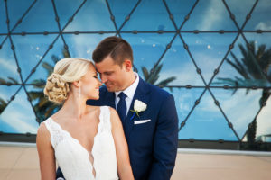 St. Pete Bride and Groom Wedding Portrait in Navy Blue Suit and Ivory Mikaella Wedding Dress | Downtown St. Pete Wedding Venue Dali Museum | Photographer Limelight Photography | Wedding Planner Exquisite Events