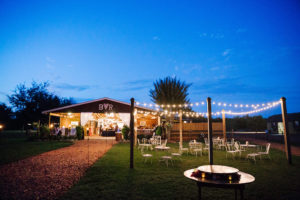 Outdoor Lounge and Fire Pit with String Lighting at Barn Wedding Reception Venue Cross Creek Ranch