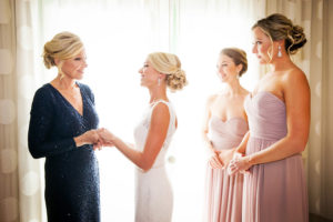 Bride Getting Ready on Wedding Day | Mom and Bridesmaids Helping Bride Put On Dress | St. Petersburg Wedding Photographer Limelight Photography