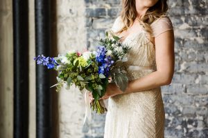Bridal Wedding Portrait in Beaded Ivory Jenny Packham Wedding Dress with Ivory and Blue Wedding Bouquet with Greenery