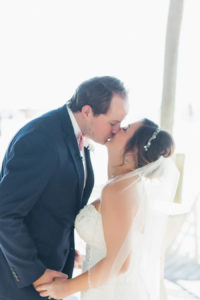 Outdoor Clearwater Beach bride and groom First look wedding portrait | Bride and groom kissing