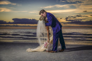 Outdoor, Waterfront Bride and Groom Kiss Wedding Portrait at Sunset | Waterfront Hotel Wedding Venue Hilton Clearwater Beach