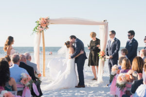 Bride and Groom Ceremony Kiss | Ivory and blush Beach chic wedding Ceremony Decor | Tampa Bay Beachfront Hotel Wedding Venue Hilton Clearwater Beach