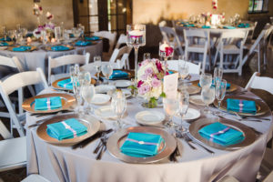 Beach Chic Wedding Reception with Lavender, Ivory and Fuchsia Wedding Centerpieces with Turquoise Napkins and Floating Tea Light Candles | Sarasota Wedding Photography by Marc Edwards Photographs | Linen Rentals Connie Duglin | Wedding Planner UNIQUE Weddings and Events