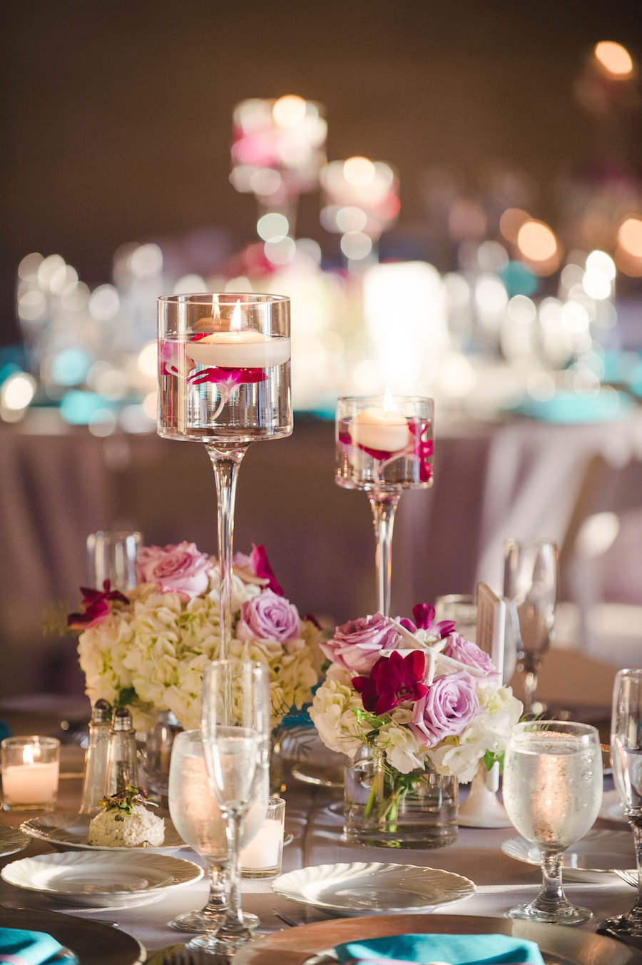 Wedding Reception with Fuchsia, Lavender, and Turquoise Centerpieces with Floating Tea Light Candles on Grey Silver Linens | Sarasota Wedding Planner UNIQUE Weddings and Events | Linens Rentals by Connie Duglin