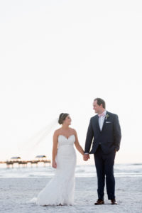 Florida Sunset beach wedding portrait | Bride and groom on sand dune with greenery | Tampa Bay Beachfront Hotel Wedding Venue Hilton Clearwater Beach