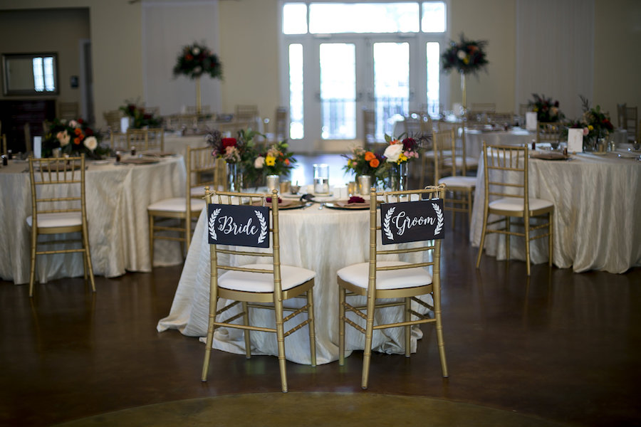 Bride and Groom Chair Chalk Signs on Gold Chiavari Chairs at Sweetheart Table | Elegant Fall Wedding Decor Ideas and Inspiration | Dade City Indoor Wedding Venue Lange Farm