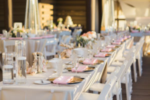 Romantic Elegant wedding reception decor with pink, peach and ivory floral centerpieces, Gold Chargers and Long Feasting Tables | Pink and white draping | Pink and white outdoor wedding reception | Tampa Bay Beachfront Hotel Wedding Venue Hilton Clearwater Beach