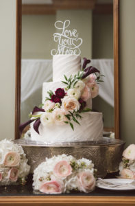 Ivory Wedding Cake with Ivory and Purple Roses and ‘Love You More’ Wedding Cake Topper on Silver Filigree Vintage Cake Stand