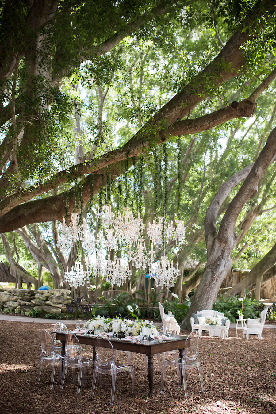 Elegant Garden Party Outdoor Wedding Reception with Chandelier Canopy, Ghost Chairs, Farm Chairs and White Floral Centerpieces | Luxury Sarasota Wedding Venue Marie Selby Gardens | Wedding Planner NK Productions