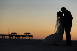 Florida Bride and groom sunset beach wedding portrait with Pier | Tampa Bay Beachfront Hotel Wedding Venue Hilton Clearwater Beach