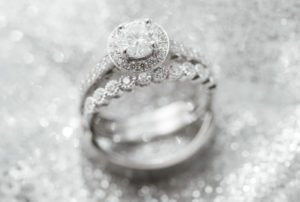 Diamond Bridal Wedding Band and Radiant Cut Engagement Ring Portrait on Silver Sparkly Linen