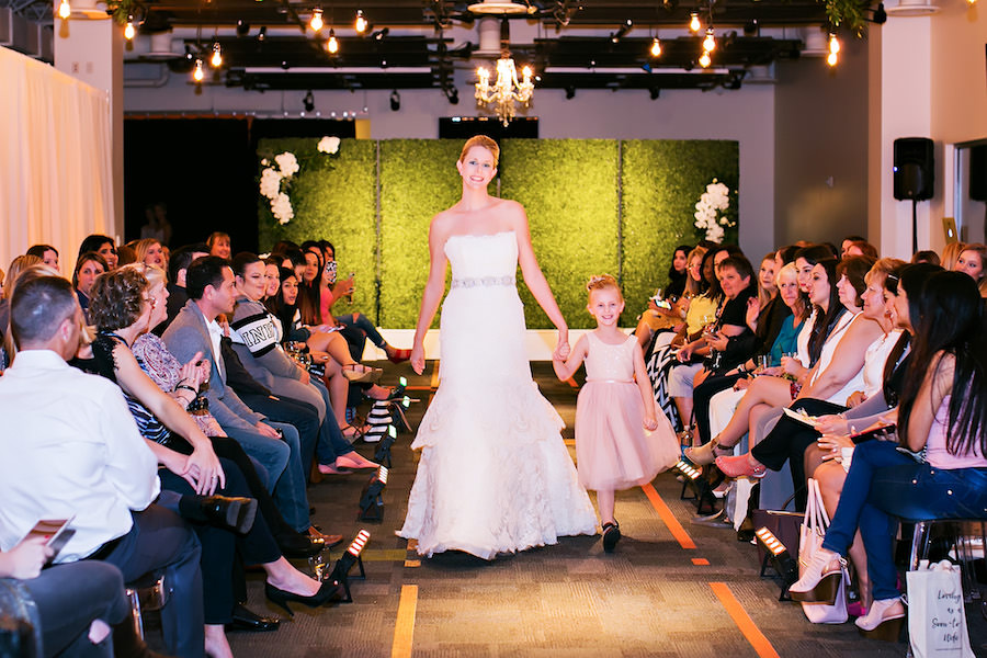 White Strapless Rivini Dari Wedding Dress with Jeweled Rhinestone Belt and Flower Girl | Marry Me Tampa Bay Wedding Week Bridal Fashion Runway Show | Tampa Bay Wedding Photographer Limelight Photography | Wedding Planner Glitz Events | Hair and Makeup Artist Michele Renee The Studio | Couture Wedding Dress Shop Isabel O'Neil Bridal