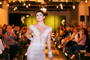 Nude Sheer Ines di Santo Low Cut Lace Wedding Dress with Sleeves | Marry Me Tampa Bay Wedding Week Bridal Fashion Runway Show | Tampa Bay Wedding Photographer Limelight Photography | Wedding Planner Glitz Events | Hair and Makeup Artist Michele Renee The Studio | Couture Wedding Dress Shop Isabel O'Neil Bridal