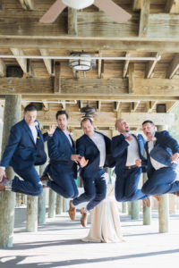 Fun Outdoor, groom and groomsmen wedding portrait | groom and groomsmen jumping | navy blue wedding suits