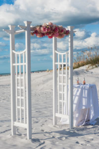 Outdoor Oceanfront Wedding Ceremony with White Arch Floral Decor with Pink and Blush Pink Flowers | Outdoor Waterfront Hotel Wedding Venue Hilton Clearwater Beach