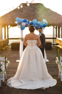 Outdoor Tampa Bay Wedding Ceremony Bride Walking Down Aisle with Blue and White Arch Decor | Tampa Bay Wedding Venue Bay Harbor Hotel