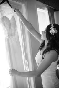 Getting Ready: Bride Looking at Gown Hanging in Window | Tampa Bay Wedding Photographer Marc Edwards Photographs