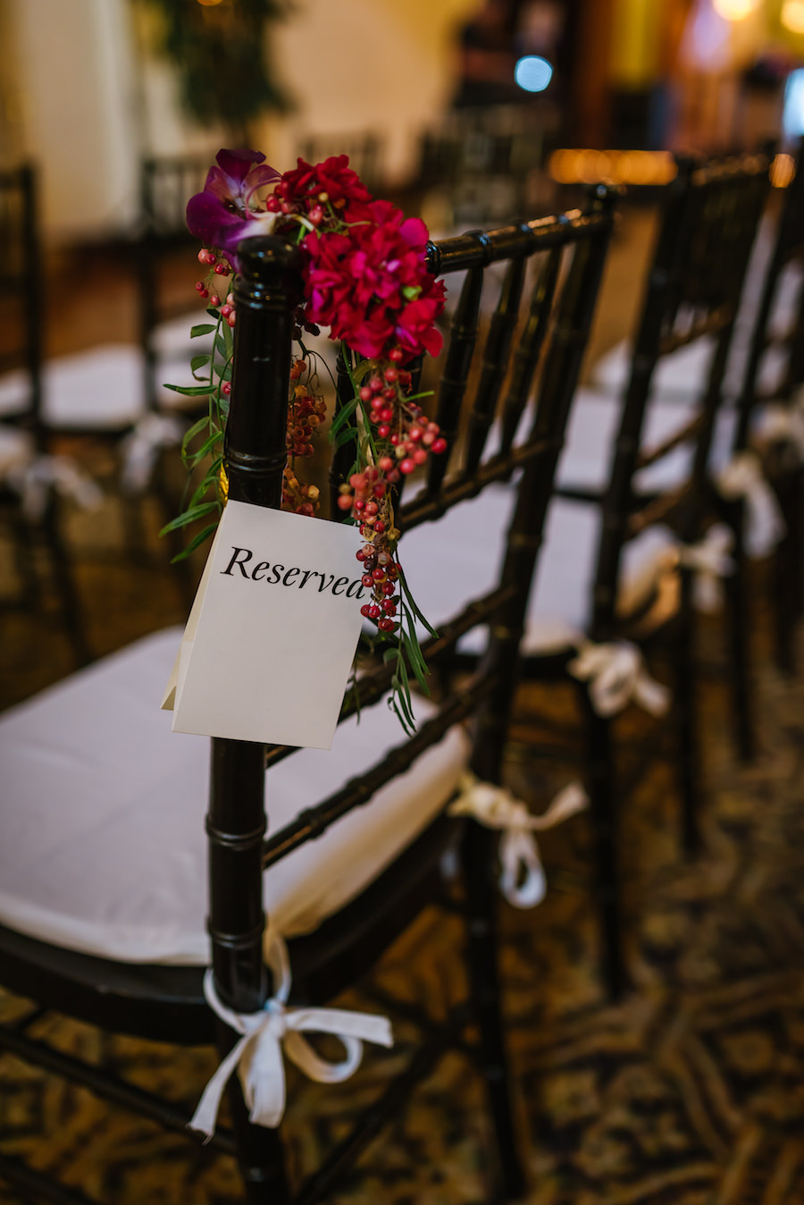 Burgundy and Fuchsia Wedding Floral Aisle Arrangement on Black Chiavari Chairs
