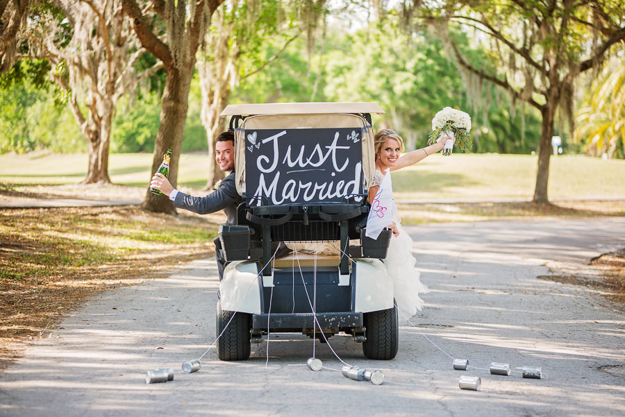 Golf Cart Wedding Exit | Bride and Groom in Just Married Golf Cart | Oldsmar Wedding Venue East Lake Woodlands Country Club