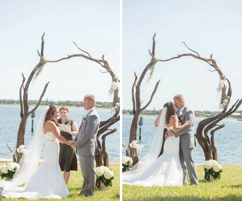 Bride and Groom First Kiss at Waterfront Wedding Ceremony with Twisted Driftwood Wedding Arch | Driftwood Wedding Arch with White Irises and Cascading Moss | Waterfront Wedding Ceremony Decor Ideas | St Petersburg Wedding Photographer Kristen Marie Photography
