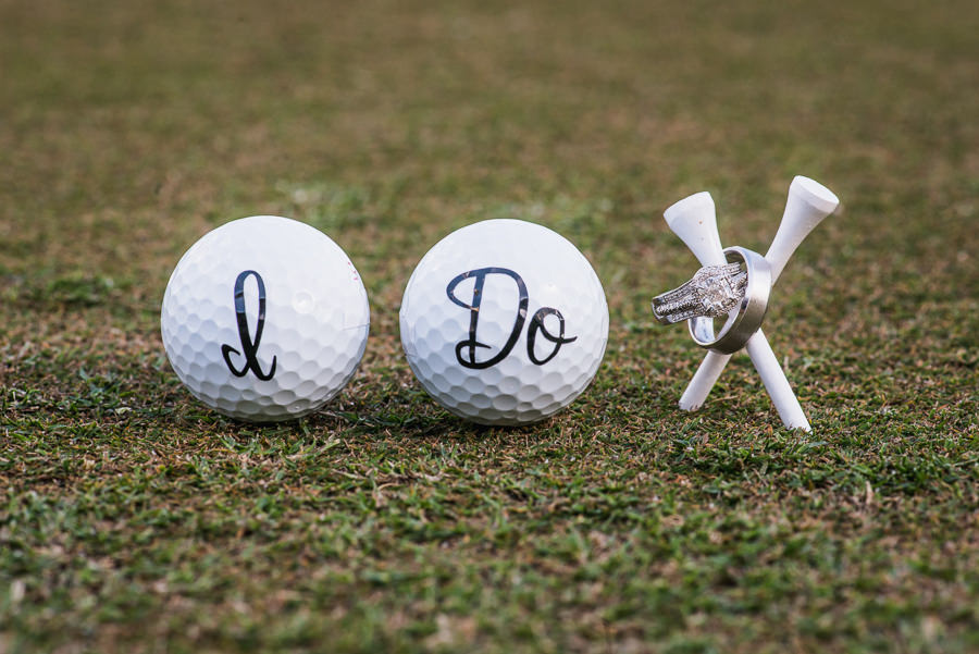 Diamond Engagement Ring and Band and Brushed Metal Wedding Band on Golf Tee with Golf Balls Saying I Do | Oldsmar Wedding Venue East Lake Woodlands Country Club