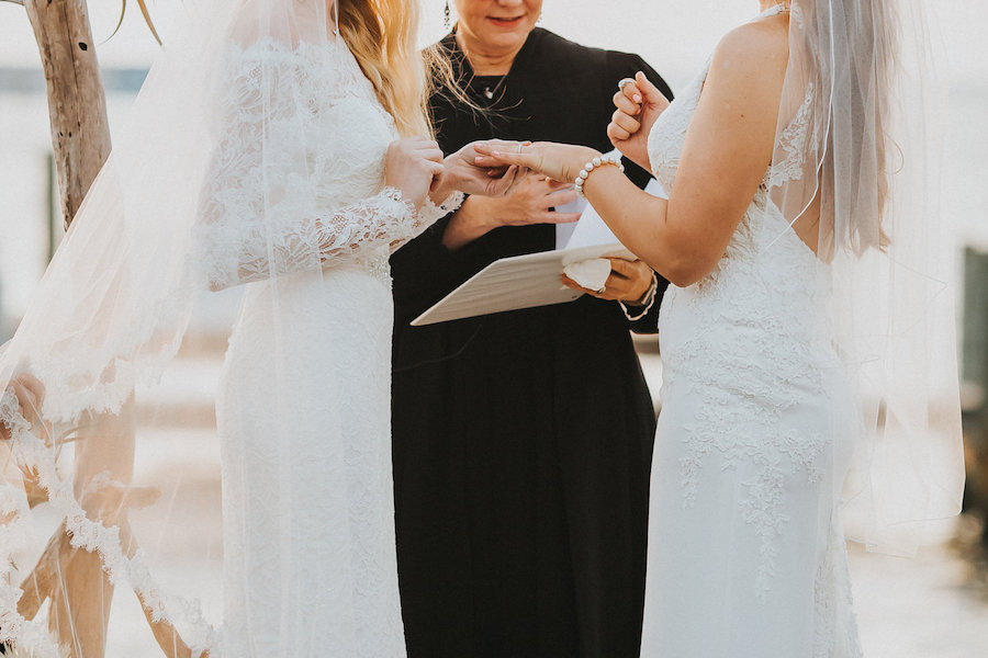 Florida Same Sex Waterfront Wedding Ceremony | Same Sex Gay Brides Exchanging Wedding Rings During Wedding Ceremony | Tampa Wedding Photographer Rad Red Creative