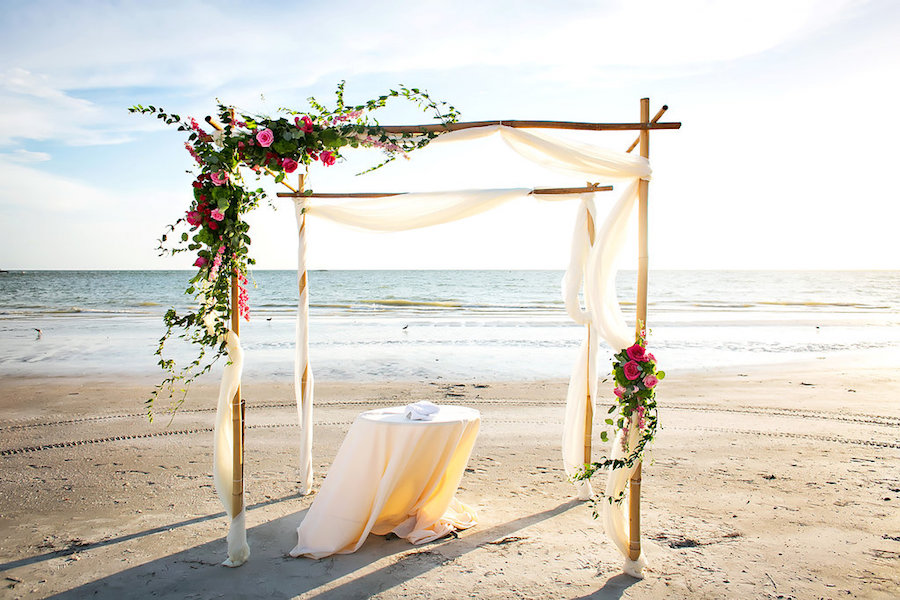 Sarasota Beach Wedding Ceremony Arch of Wood and White Tulle with Greenery and Pink Roses | Sarasota Wedding Photography by Limelight Photography