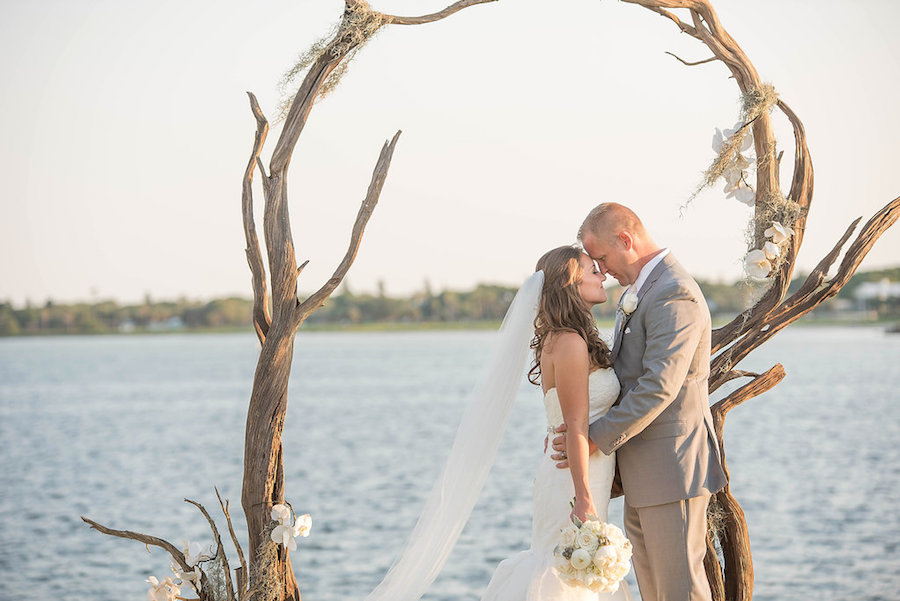 Tampa Bay Waterfront Bride and Groom Wedding Portrait Under Beachwood Wedding Arch | St. Petersburg Wedding Photographer Kristen Marie Photography