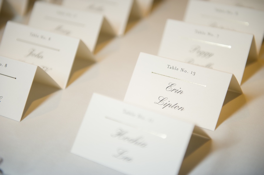 Traditional Formal Name Card Table Display with Ivory and Gold Place Cards in Black Cursive Writing