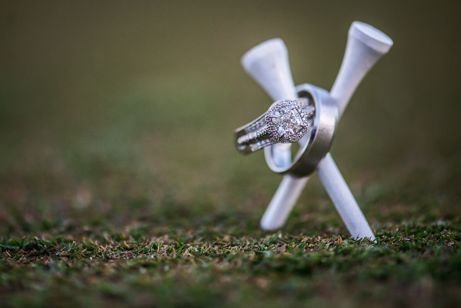 Diamond Halo Engagement Ring and Bridal Wedding Band and Brushed Metal Wedding Band on White Golf Tees