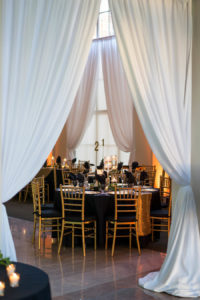 Black and Gold Wedding Reception Ideas and Inspiration with Floating Candle Centerpieces and Gold Chiavari Chairs and Chargers | Downtown Tampa Wedding Venue The Vault | Marc Edwards PhotogaphsWedding Photographer Marc Edwards Photographs