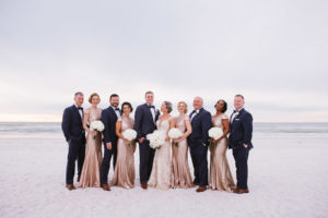 St. Pete Beach Bridal Party Wedding Portrait with Bridesmaids in Gold Sequin Gowns, Groomsmen in Navy Blue Suits with Bowties and Bride in Ivory Lace Martina Liana Gown | St. Petersburg Wedding Venue The Don CeSar | Tampa Bay Wedding Photographer Jonathan Fanning Studio and Gallery