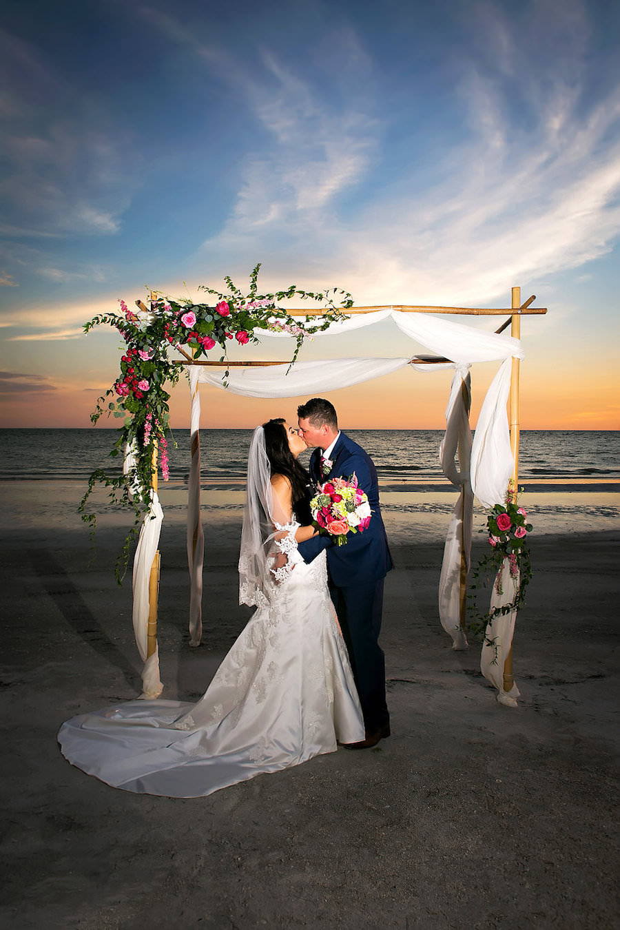 Bride and Groom Wedding Day Portrait on Sarasota Beach at Sunset Under Wedding Arch | Sarasota Wedding Photographer Limelight Photography