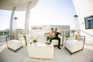 Modern Rooftop Bride and Groom Wedding Portrait with White Lounge Furniture | Tampa Bay Bridal Shop Isabel O'Neil Bridal | Wedding Photographer Limelight Photography | Downtown Tampa Venue Glazer's Children Museum | Rental and Decor Company A Chair Affair