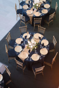 Black and Gold Wedding Reception Ideas and Inspiration with Floating Candle Centerpieces and Gold Chiavari Chairs and Chargers | Downtown Tampa Wedding Venue The Vault | Wedding Photographer Marc Edwards Photographs