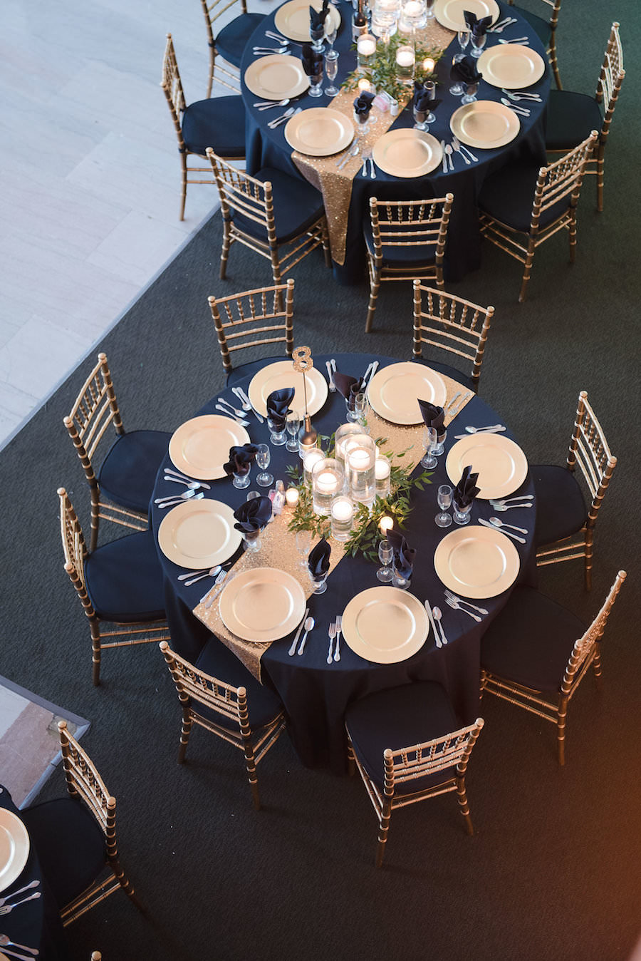 Black and Gold Wedding Reception Ideas and Inspiration with Floating Candle Centerpieces and Gold Chiavari Chairs and Chargers | Downtown Tampa Wedding Venue The Vault | Wedding Photographer Marc Edwards Photographs