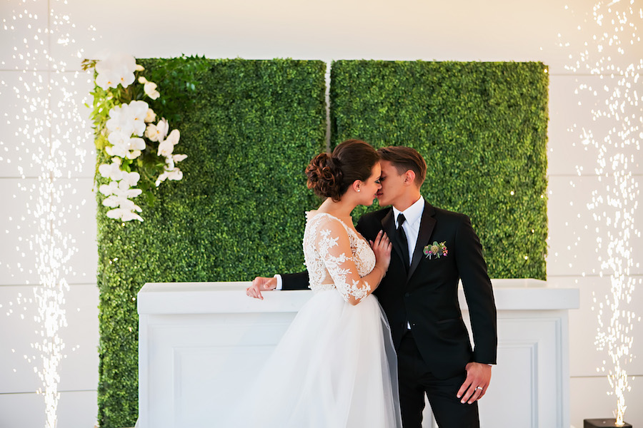 Modern Greenery Inspired Rooftop Garden Wedding Decor | Greenery Hedge Wall Ceremony Backdrop with Sparkler Fireworks | Tampa Bay Bridal Shop Isabel O'Neil Bridal | Rental and Decor Company A Chair Affair | Wedding Photographer Limelight Photography | Downtown Tampa Venue Glazer's Children Museum | Lighting Nature Coast Entertainment Services