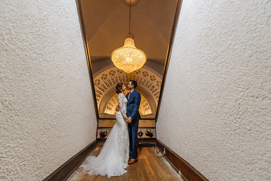 St. Petersburg Bride and Groom Wedding Portrait in Navy Blue Suit and Long Sleeve Lace Wedding Dress | St. Pete Wedding Videography by Imagery Wedding Films