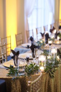Black and Gold Wedding Reception Ideas and Inspiration with Floating Candle Centerpieces and Gold Chiavari Chairs and Chargers with Gold Glitter Linens | Downtown Tampa Wedding Venue The Vault