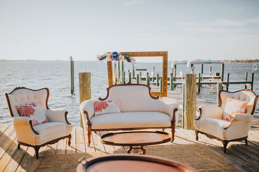 Tampa Outdoor Waterfront Wedding Reception Seating Area with Vintage Couches and Coral Cushions