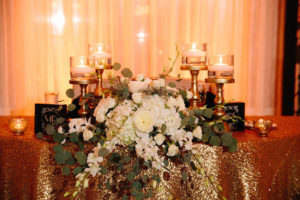 Ivory and Gold Sweetheart Table with Gold Glitter Linens with Ivory Roses and Floating Candles | St. Petersburg Wedding Venue The Don CeSar