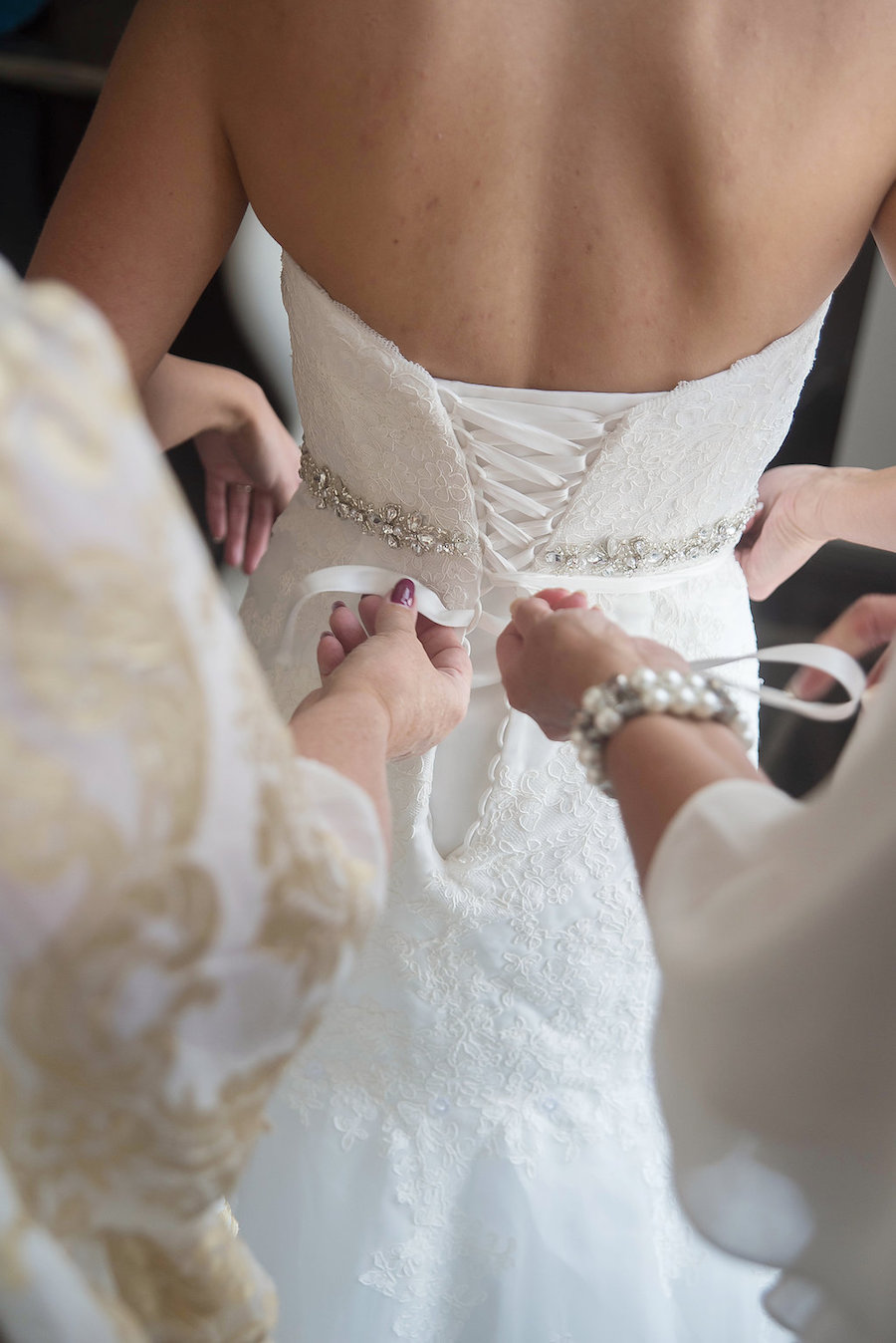 Bride Getting Dressed/Ready | Cream Lace Trumpet Style Wedding Dress with Rhinestone Belt and Lace Up Corset Back | St. Petersburg Wedding Photographer Kristen Marie Photography