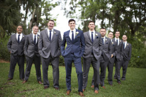 groom in blue suit groomsmen in grey