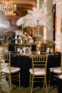 Ivory, Black and Gold Wedding Reception with Tall White Feather Centerpieces and Gold Chiavari Chairs with Black Linens | St. Petersburg Wedding Venue The Don CeSar | Tampa Bay Wedding Photographer Jonathan Fanning Studio and Gallery | A Chair Affair