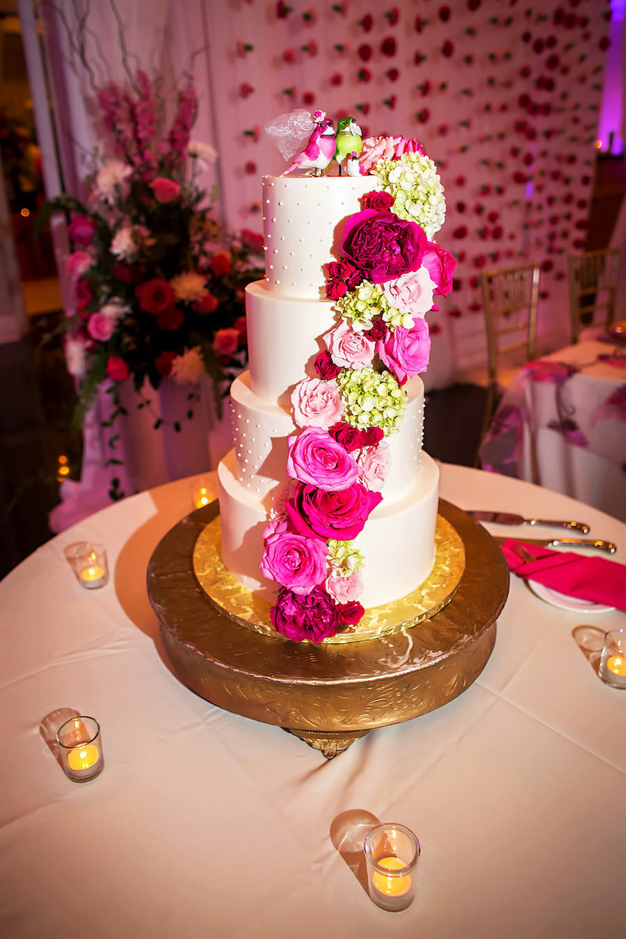 Four Tier Lilly Pulitzer Theme White Wedding Cake with Pink and Green Roses and Hydrangea on Gold Cake Stand | Sarasota Wedding Photography by Limelight Photography