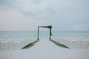 Outdoor Sarasota Wedding Ceremony with Palm Lined Aisle and Wooden Arch | Sarasota Wedding Planner Jennifer Matteo Event Planning